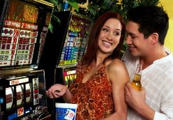 Couple playing at slot machines